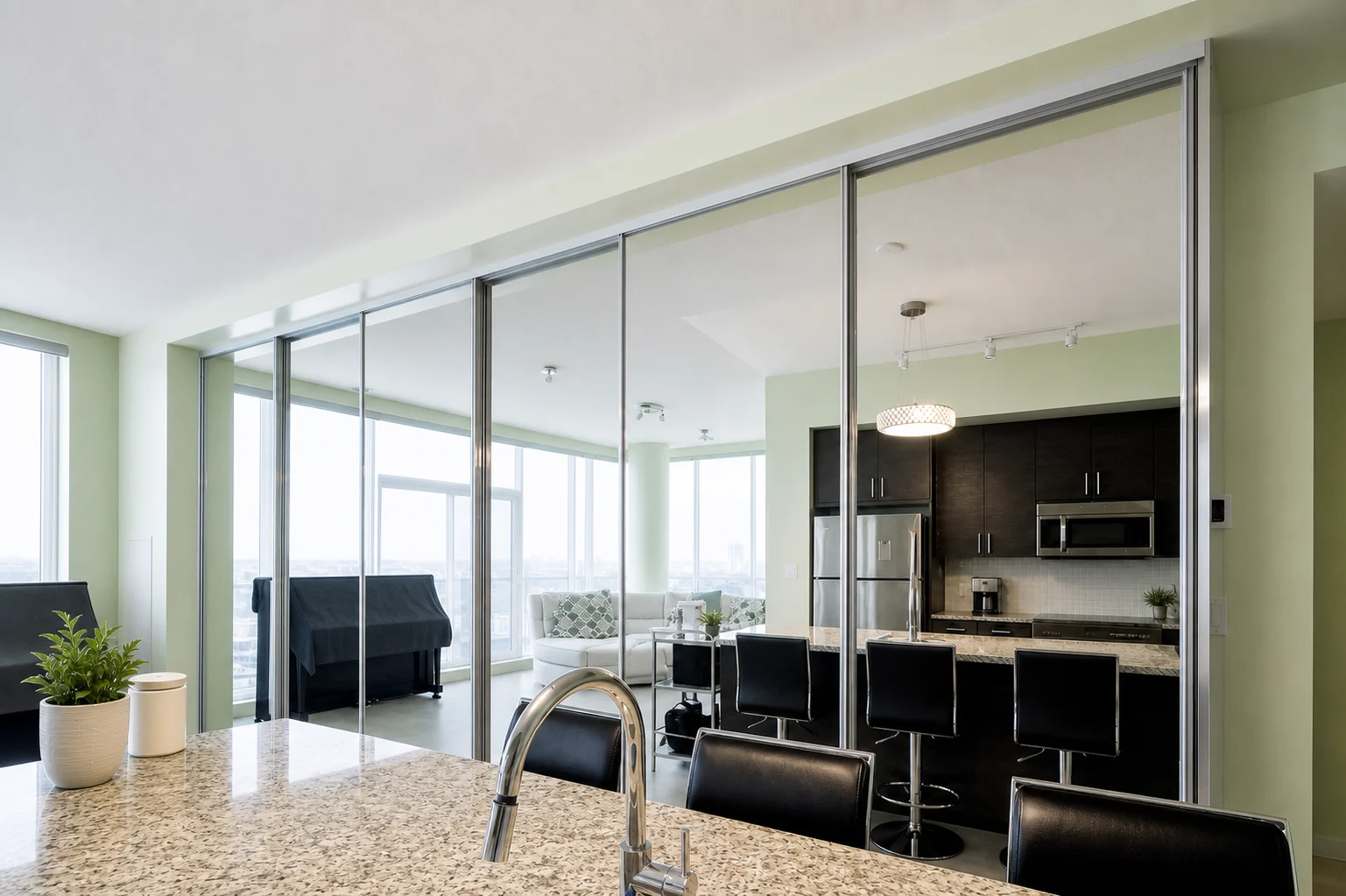 Six-panel mirrored sliding doors concealing full-wall storage.