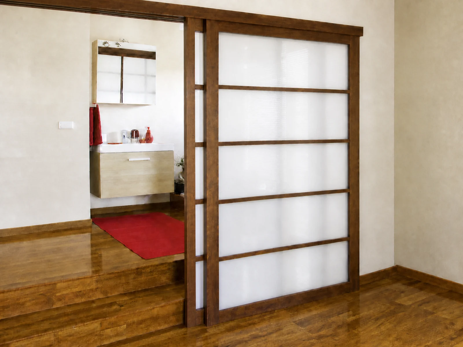 Dark wood-style framed sliding doors with translucent glass at a bathroom transition.